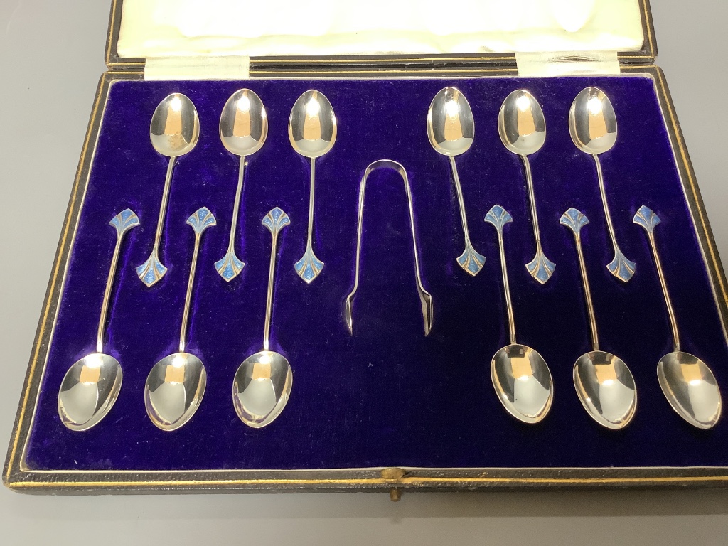 Twelve pairs of Walker & Hall silver-bladed bone-handled fish eaters, a set of six silver Apostle teaspoons and sugar tongs and a set of twelve silver coffee spoons